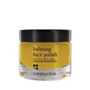 glazen pot met gele inhoud, zwart deksel en zwarte tekst (balming face polish)